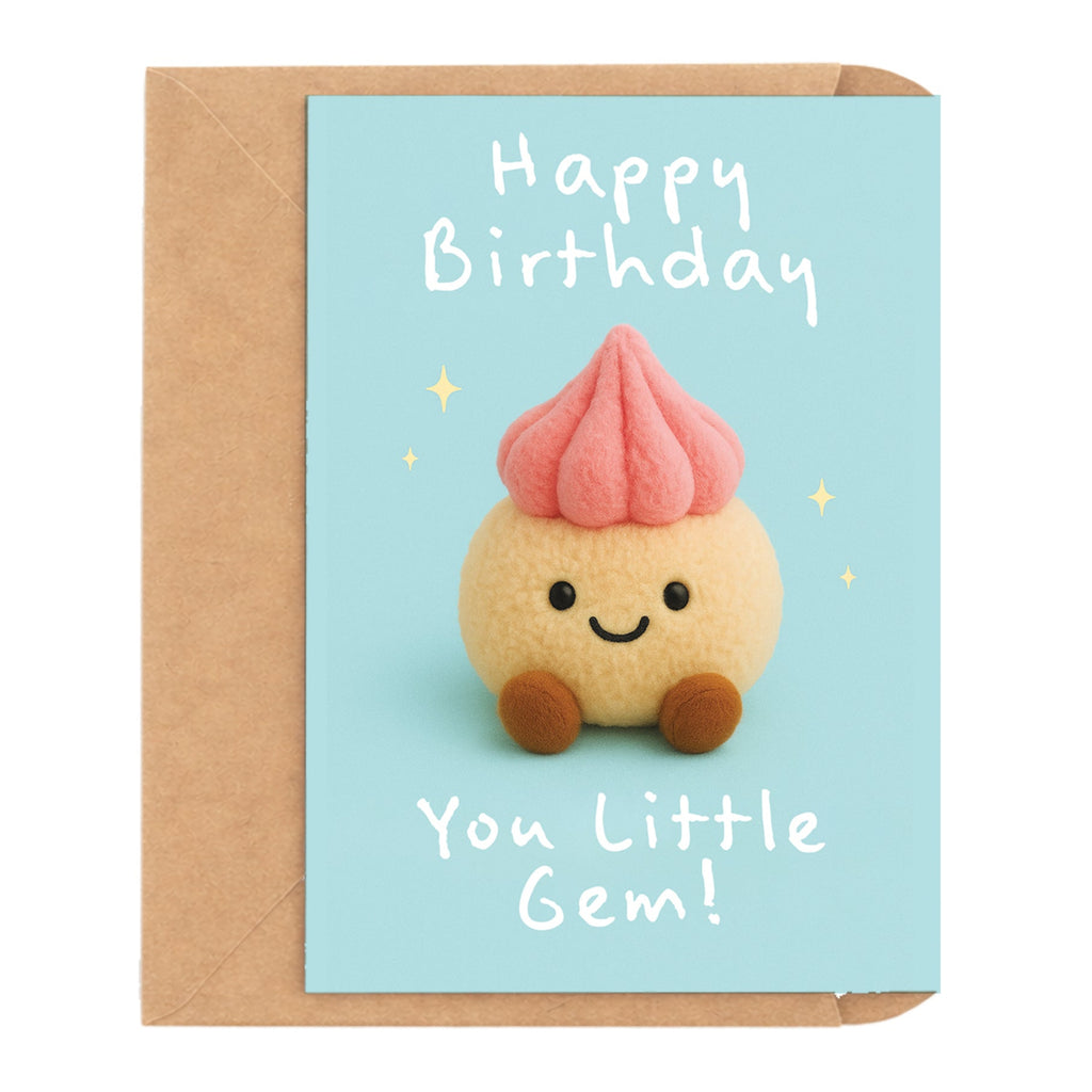 A cute birthday card with a kraft envelope, featuring a smiling little cupcake character on a light blue background with the text 'Happy Birthday You Little Gem!'.
